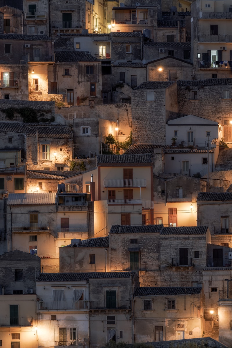 Photo by Marco Grosso Old stone buildings illuminated at dusk